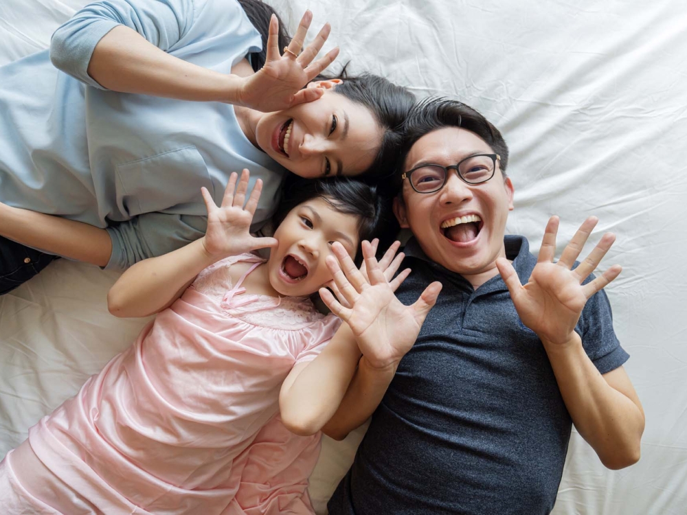 Asian Family mother father and daughter making a fun sleep play in living room home background.